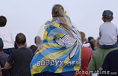 A girl in a carnival costume on her fatherÃƒÆ’Ã‚Â¢ÃƒÂ¢Ã¢â‚¬Å¡Ã‚Â¬ÃƒÂ¢Ã¢â‚¬Å¾Ã‚Â¢s shoulders is watching a concert. Editorial Stock Photo